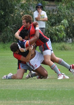 Tom Fry (top) and Clinton Strickland (low) combine to bring down a Roosters player.