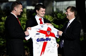 England Academy vice-captain Ben Currie and captain John Bateman present British high commissioner Paul Madden with a signed jersey yesterday. Photo: Melissa Adams