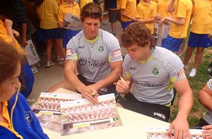Raiders Jarrad Kennedy and Shaun Fensom sign some posters at Bungendore Primary