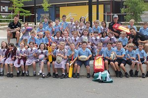 Jake Foster, Josh Dugan and Josh McCrone with the children at St Johns Vianney's Primary School.