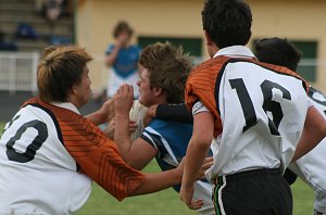 Andrew Montgomery (De La Salle) tries to bust thru' the academy defence 