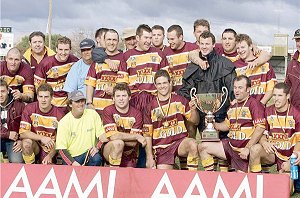 Group Nine players celebrate after winning the Centenary Plate grand final at Fisher Park on Saturday.