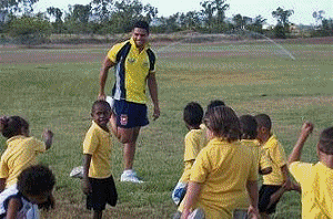 Obe Geia helping kids learn about footy