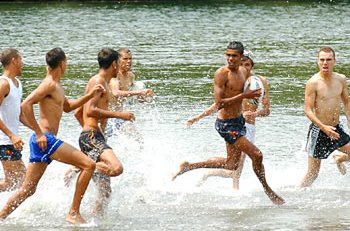 The Kempsey U-20s kick up their heels in the Macleay River. / The Daily Telegraph