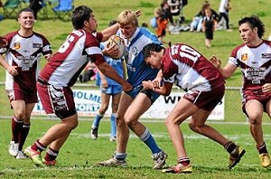 Macquarie Raiders Jackson Merritt takes on a number of Wellington defenders in the under-18s Group 11 grand-final.