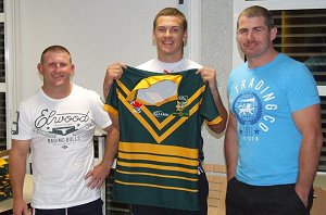 Tyson Cleal is presented with his Green & Gold Jersey by AIS coaches Brad Drew & Andrew Ryan 