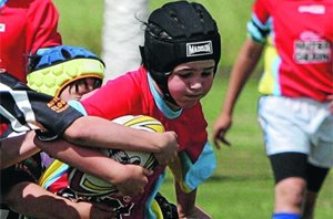 Sacred Heart Primary School Cootamundra ball-carrier Rogan Leahy is brought down by the Griffith Small Schools defence.